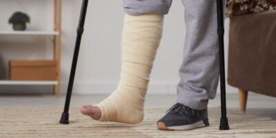 A man with a broken leg using crutches.