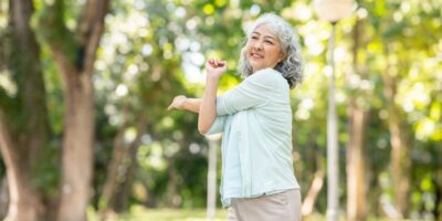 A woman stretching in a park.