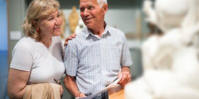 A couple looking at a statue in a museum