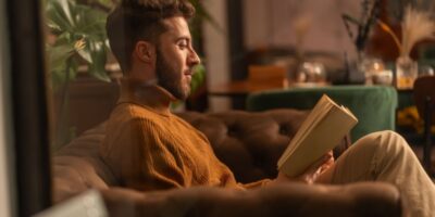 A man reading a book at home.