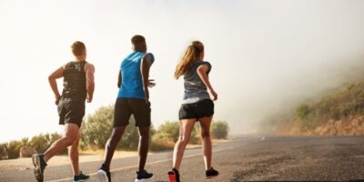 Three people running outdoors.