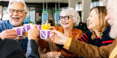 A group of people talking and drinking tea.
