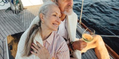 A couple sitting on a yacht deck.